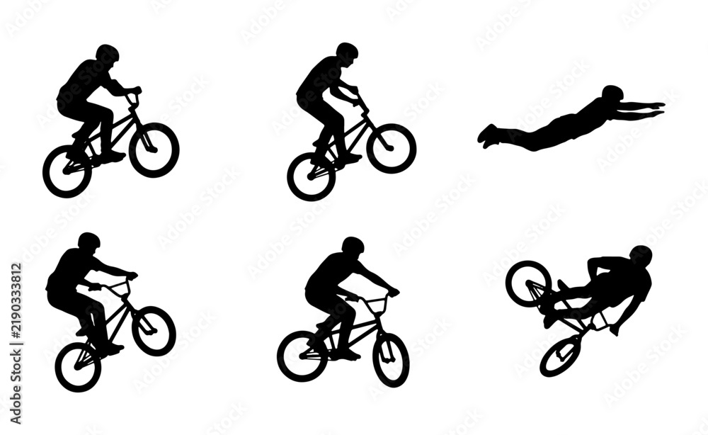 Fototapeta premium BMX cyclists performing stunts and a superman dive silhouette