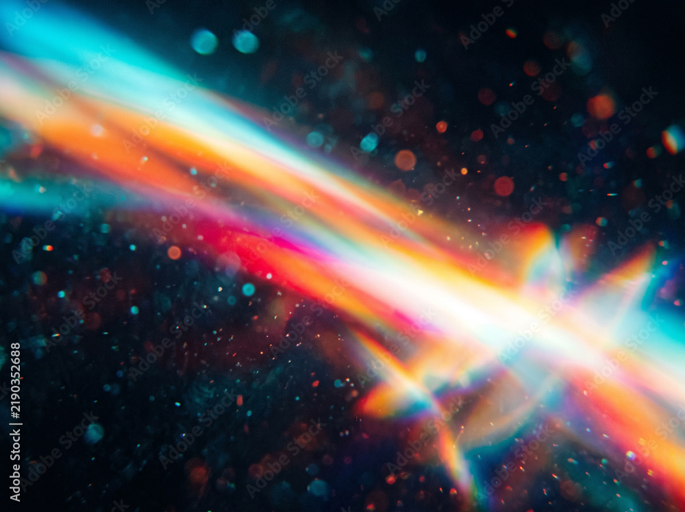 Obraz premium Vibrant colorful light streaks and bokeh particles creating magical glowing background