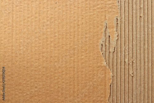 Brown cardboard sheet abstract background, texture of recycle paper box in old vintage pattern with ripped edges.