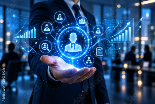 A businessman presents glowing digital icons representing human resources and data analysis