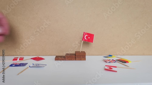 Miniature Turkish Flag Among International Flags and Wooden Blocks