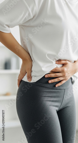 Close-up of a person holding their stomach, symbolizing pain or discomfort, often related to digestion or health.