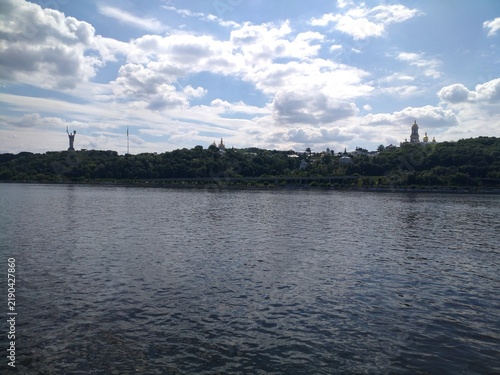 Obraz na płótnie River view of city skyline with historic monastery and monument