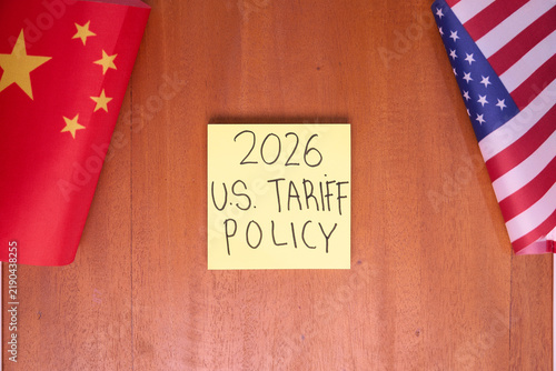 2026 U.S. tariff policy note between China and US flags on wooden table for trade war and economic policy concept