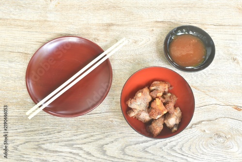 fried fermenting pork cartilage bone with garlic on bowl dipping spicy chili sauce