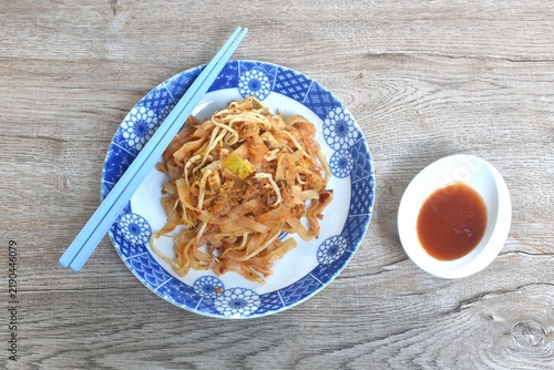 Pad Thai stir fried rice noodles with egg and bean sprout couple garlic chive on plate dipping chili sauce