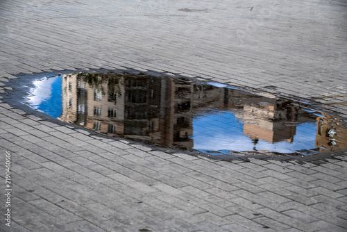 Fotografie The street is reflected in a rain puddle on an autumn day