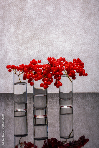 Fotografía Still life with three glass glasses and red viburnum berries