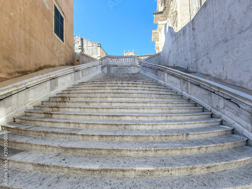 Majestic Jesuit Stairs in Dubrovnik showcasing historic baroque architecture, grandeur, and cultural heritage under a blue sky.