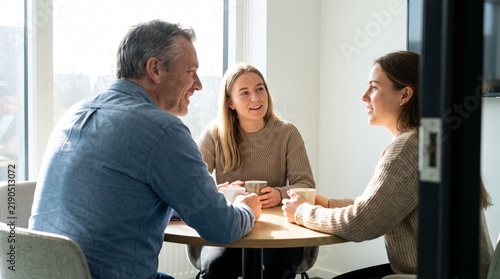 Team of colleagues having a conversation in a bright modern office