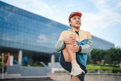 Obraz na plátně Adult asian man runner stretching kneel and leg wear sports outfit training for
