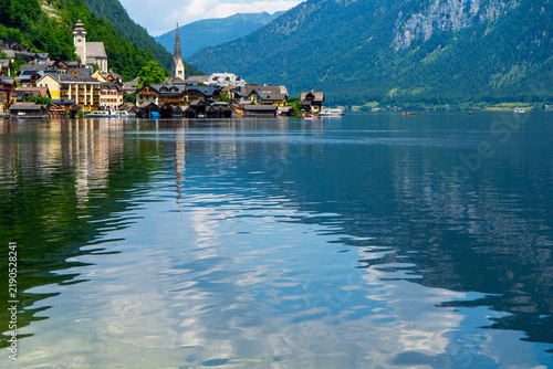 Houses on a Mountain by Lake in Hallstatt Village Austria. Embankment near blue water.