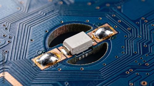 Konstfotografi White surface mount LED soldered onto blue printed circuit board for electronic designs