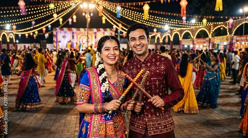 Young Indian couple in traditional attire performing Garba dance with dandiya sticks at Navratri festival