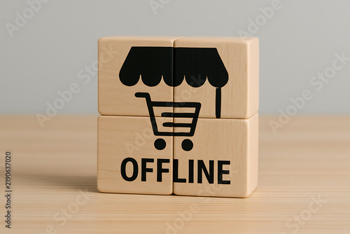 Wooden blocks displaying a storefront symbol and the word offline close up shot