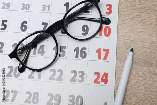 Paper calendar on the table with eyeglasses