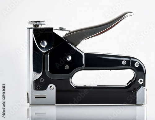 black staple gun isolated on clean white studio surface