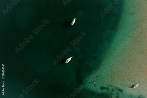 View of a boat from a drone in dark bluegreen water