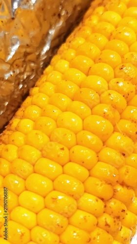 Baked Corn on the Cob in Aluminum Foil with Seasoning Close Up