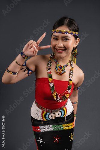 Obraz na plátně Smiling Young Woman Wearing Traditional Murut Tahol Simba Costume of Sabah Malay