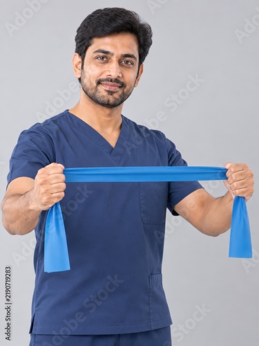 Physical therapist demonstrates use of resistance band