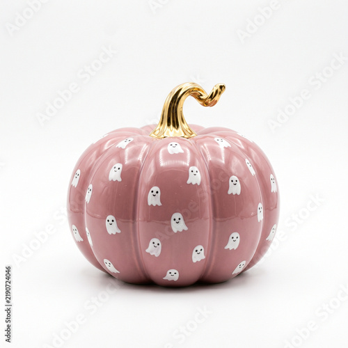Decorative pink pumpkin with ghost print and golden stem  
