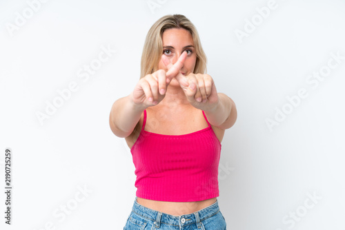 Canvastavla Young caucasian woman isolated on white background making stop gesture with her