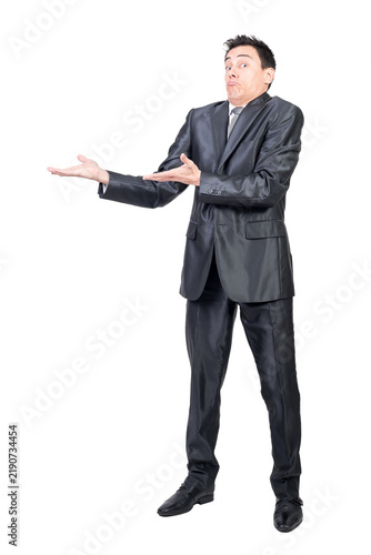 Quadro su tela Full body of amazed male in formal suit pointing aside with hands while promotin