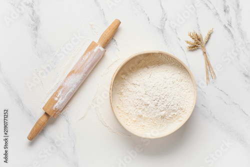 Quadro su tela Baking and culinary arts, wooden rolling pin with flour in a sieve and wheat ear