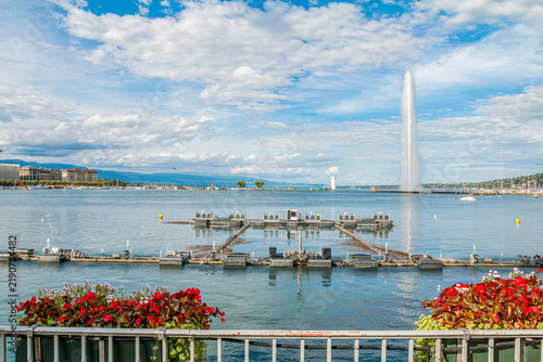 Musical dancing water fountain show in Jardin Anglais with the famous Jet d'Eau landmark in the background on Lake Geneva, scenic summer travel destination in Geneva, Switzerland.