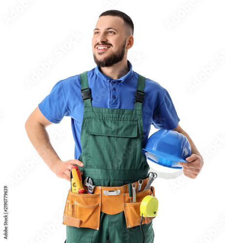 Happy male construction worker with hardhat and professional tools isolated o...