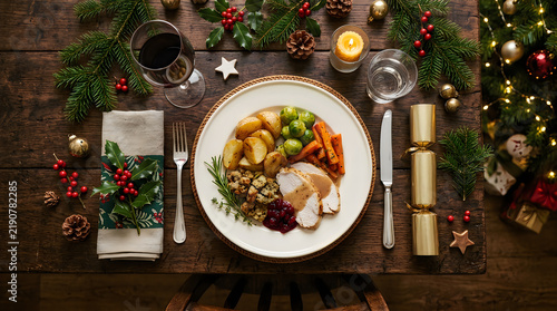 Traditional christmas roast dinner table setting with festive decor, christmas
