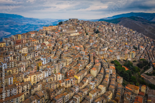 Sunrise view of the rooftops of Gangi with morning fog. Sicily, Italy. August 2024. Aerial drone picture.