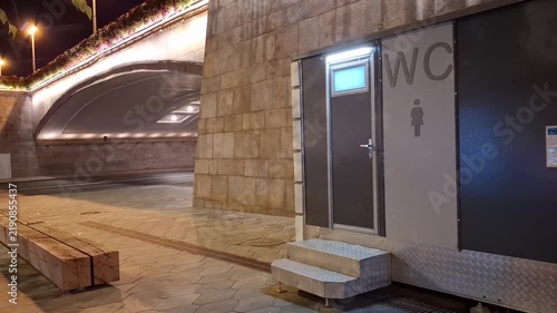 Public restroom door with toilet sign in an underground passage. Urban facility, interior architecture, hygiene access, public space, wayfinding concept.
