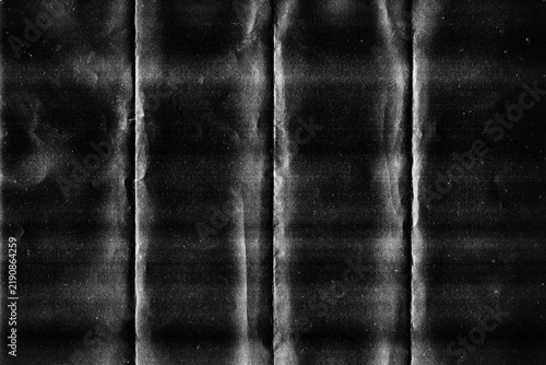 Grunge black folded paper texture with vertical crease lines and wrinkled effect