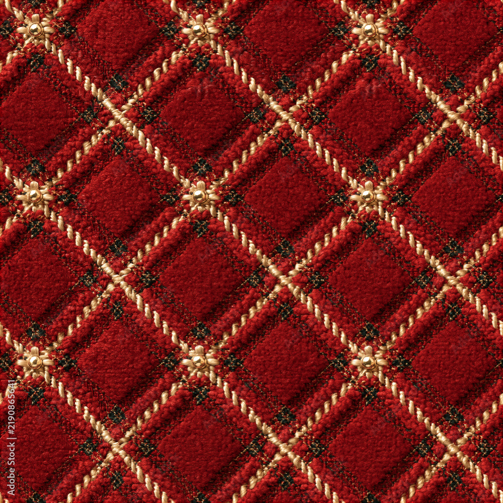 Obraz premium Seamless pattern red quilted fabric showing a diamond pattern with gold twisted thread and small metallic flower decorations. Luxurious texture