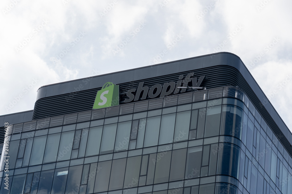 Obraz premium Toronto, Ontario, Canada - September 13, 2026: Closeup Shopify logo and sign on the office building. Toronto, Ontario, Canada. Shopify Inc is a Canadian multinational e commerce company. 