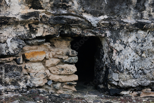 A small entrance to an old, ruined building.