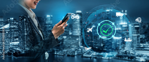 фотографія Businesswoman engages with smartphone displaying digital technology amidst a vibrant city skyline, highlighting advancements in logistics and communication for a dynamic future