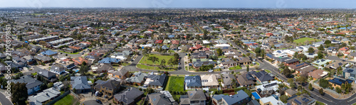 Expansive aerial panoramic view of established residential neighborhoods with rooftops local parks, and connected street grids across Tarneit in outer west Melbourne, Victoria, Australia