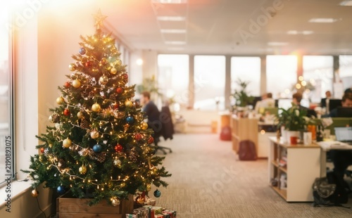 Decorated Christmas tree in a modern office workplace during holiday season for corporate celebration
