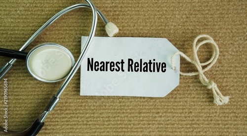 Obraz na płótnie Stethoscope and paper tag with the words Nearest Relative is a specific legal role with rights and powers under mental health laws, such as the Mental Health Act, to protect a patient's interests