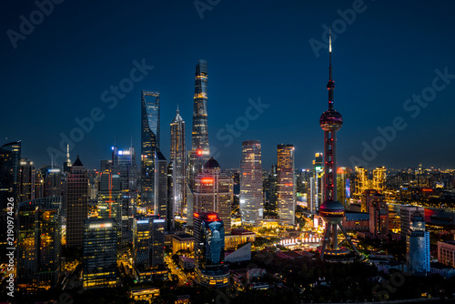 Canvas Print Shanghai CBD skyline illuminated at night, showcasing the iconic and majestic skyscrapers, representing China's immense economic power and future growth