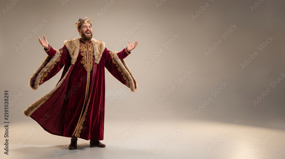 Fototapeta premium King in royal robe laughing with arms wide open