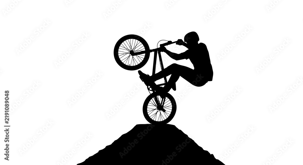 Obraz premium Silhouette of BMX rider performing a wheelie on a dirt ramp against a white background