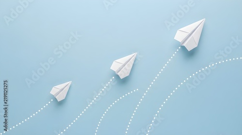 Three white paper planes flying upward on a clean light blue background with dotted lines showing their paths for business strategy and creative leadership growth concepts