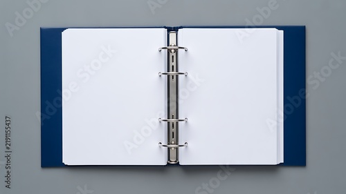 Open blank ring binder with empty white pages on a blue background