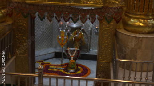 Obraz na plátne Sacred Shiva Lingam Idol Adorned with Flowers and Garlands in a Golden Temple Sa