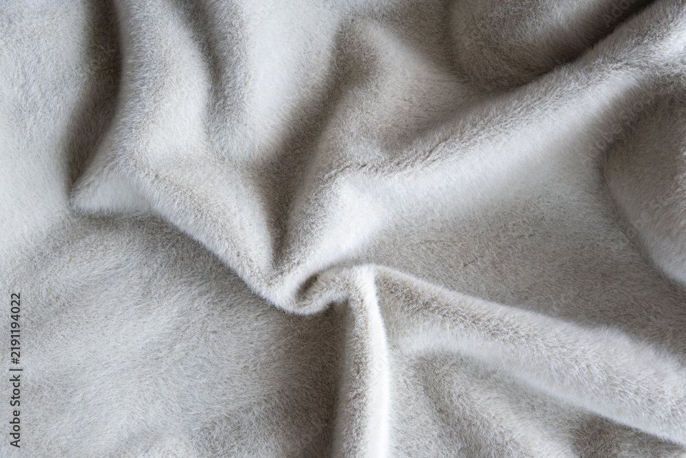 Fototapeta premium Soft gray wool blanket close-up texture with cozy fur pile for interior. Gentle folds for home.