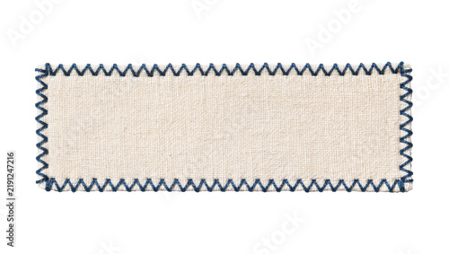 Rectangular beige fabric label with zigzag blue stitching, isolated on transparent background